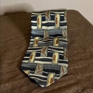Abstract silk tie lots of colours blues brown leaves